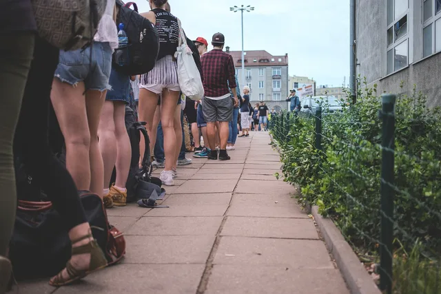 people, city, crowd, group, line, long, patience, queue, stand, standing, street, wait, waiting, queue, queue, queue, queue, queue. Planning queue capacity for a sudden event spike